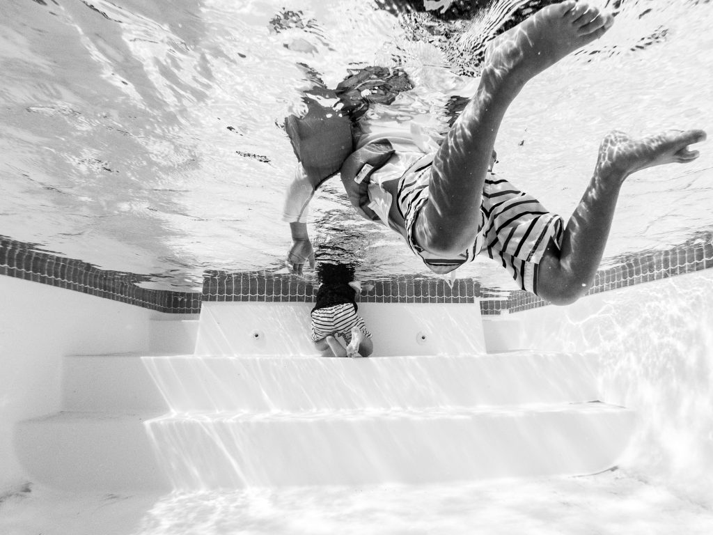 Children swimming in a pool, black and white photograph