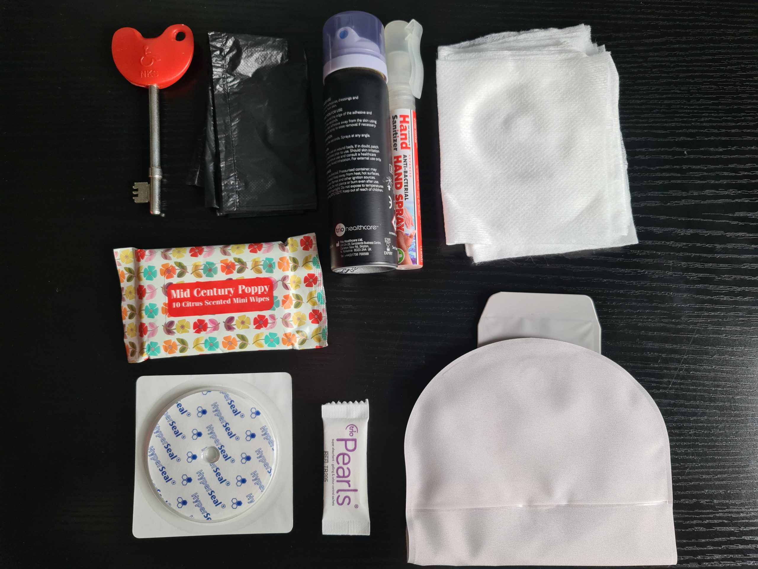 Items laid out for an ostomy bag emergency change kit