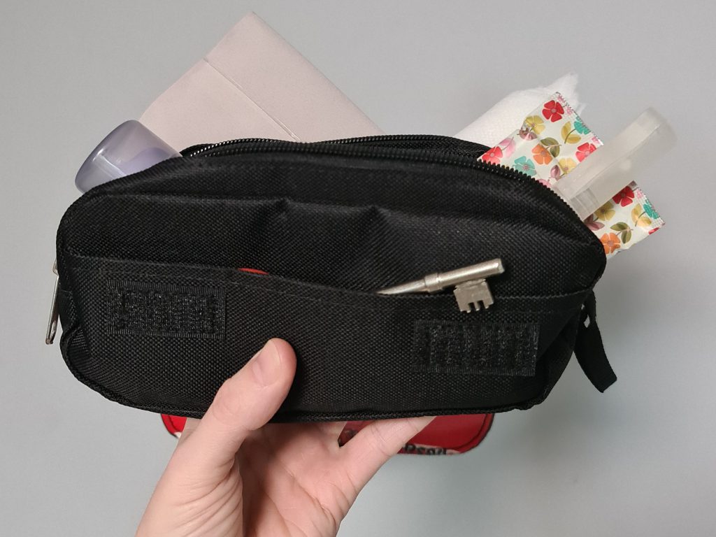 Sahara's emergency change kit in a neat black bag, with side pockets and velcro fastening, her radar key and various items showing as a demonstration of what she carries.