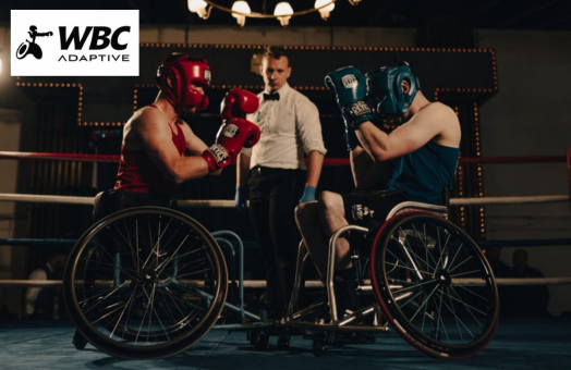 A competitive adaptive boxing match with one boxer in red and the other in blue with a referee in the background