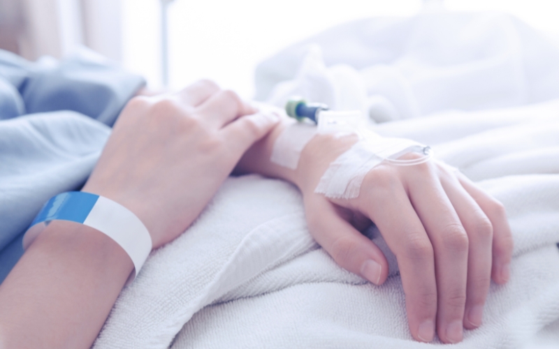 close up of person's hands in a hospital with canula